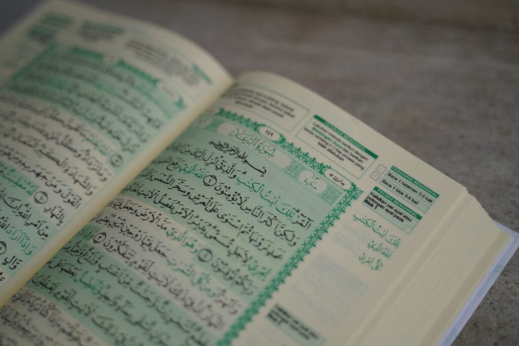Open Quran displaying Arabic script, close-up view, suitable for religious and educational themes.